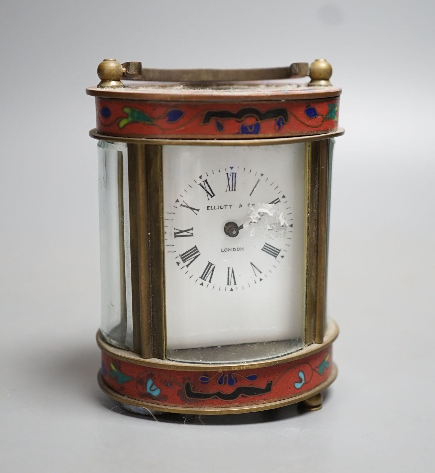 A mignonette oval brass and champleve enamelled timepiece 9cm